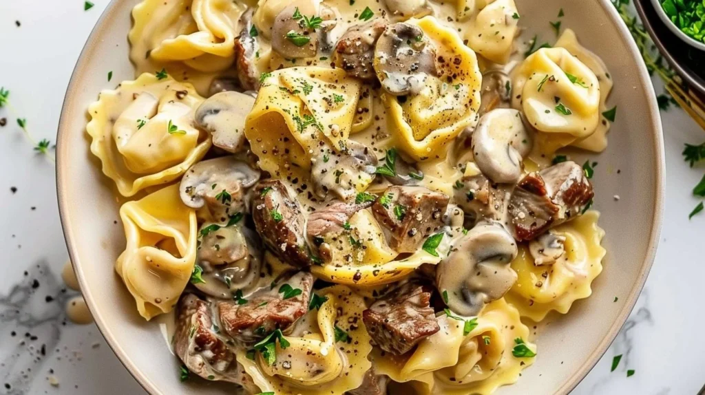 Creamy garlic steak tortellini with mushrooms in a bowl