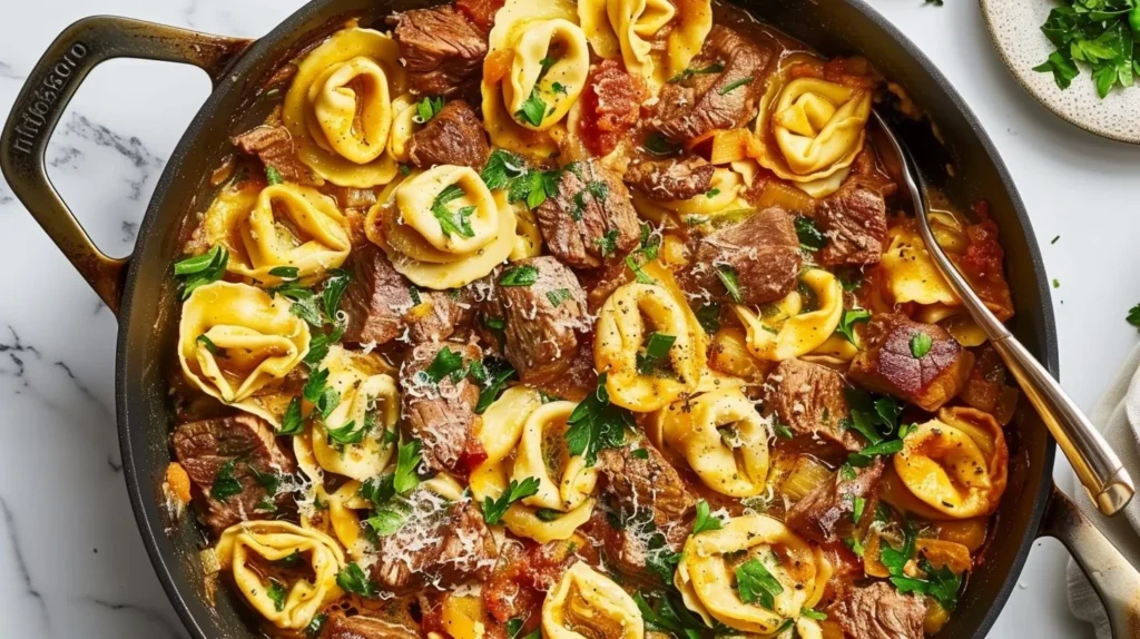 Garlic Steak Tortellini Skillet dish with fresh herbs and steak slices